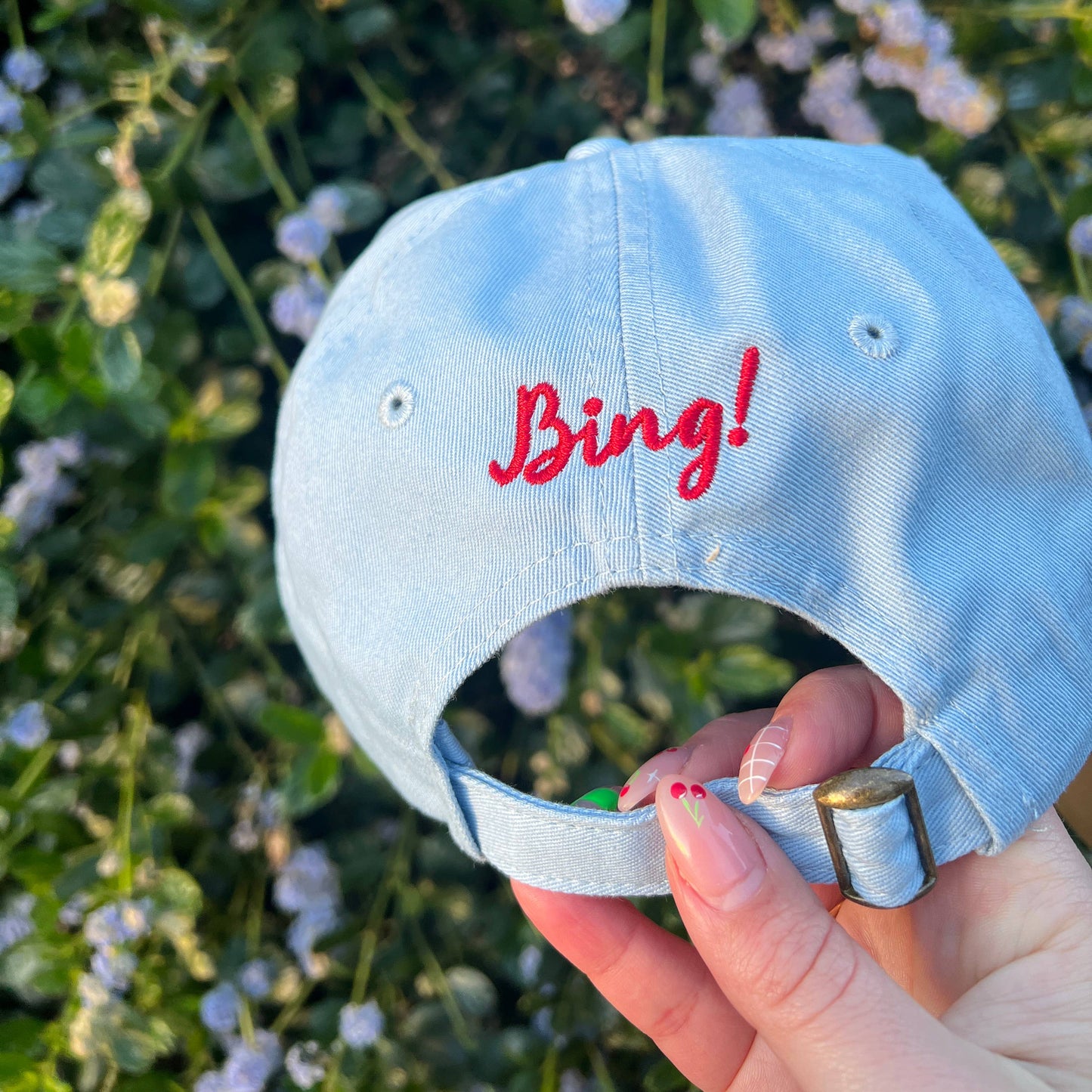 Has the text "Bing!" embroidered in red on center back of hat above adjustable strap