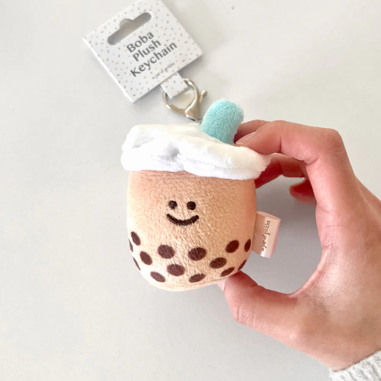 Boba plush keychain with a teal colored straw