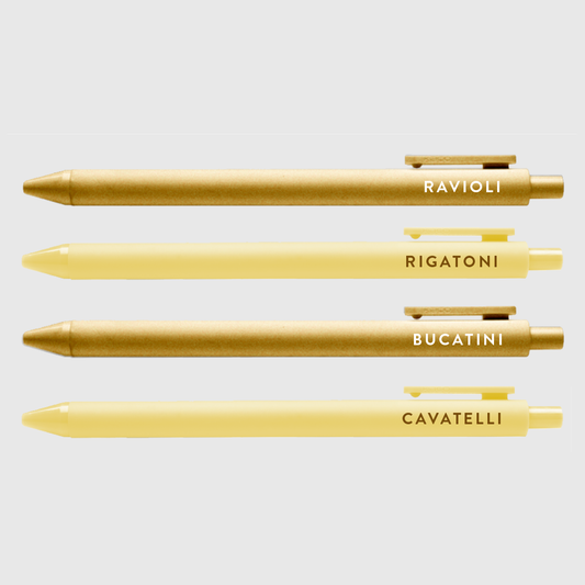Set of 4 pasta pen set with text -- pen barrels are either gold or light yellow. Text on gold pens read "ravioli" and "bucatini", text on light yellow read "rigatoni" and "cavatelli"