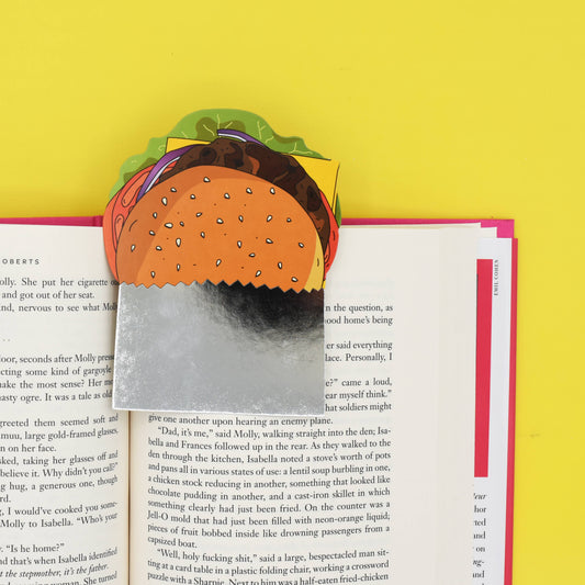 Hamburger-shaped paper bookmark on an open book with a yellow background