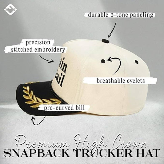 Beige and black snapback hat with text highlighting features on a gray background