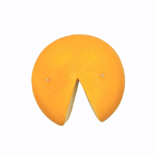 Candle that looks like wheel of pecorino cheese -- view from above. Two wicks, one on far right the other far left.