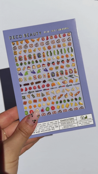boomerang video of someone holding the sheet of charcuterie themed nail art stickers