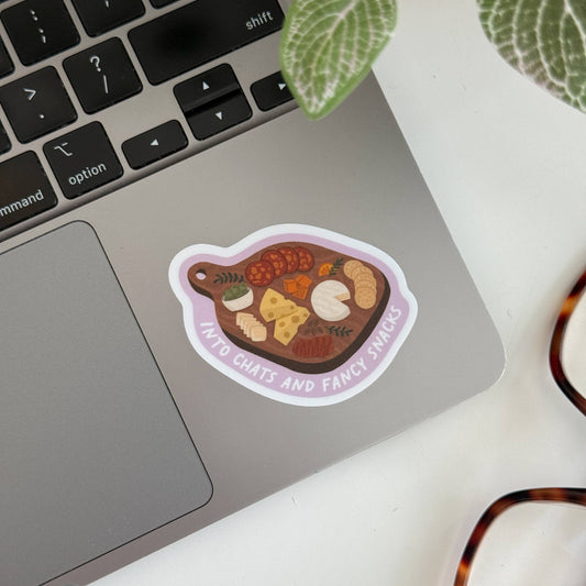 charcuterie board sticker with text "into chats and fancy snacks"