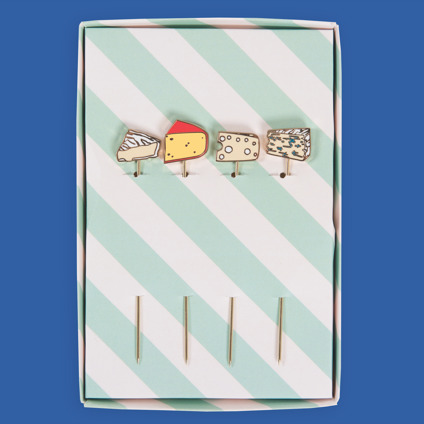 Set of cheese-themed cocktail picks in a striped box on a blue background