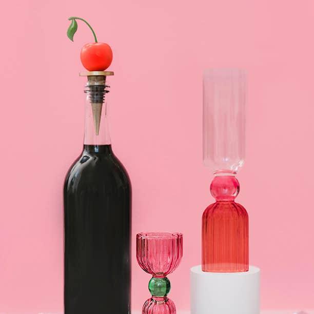 Cherry wine stopper being used on bottle