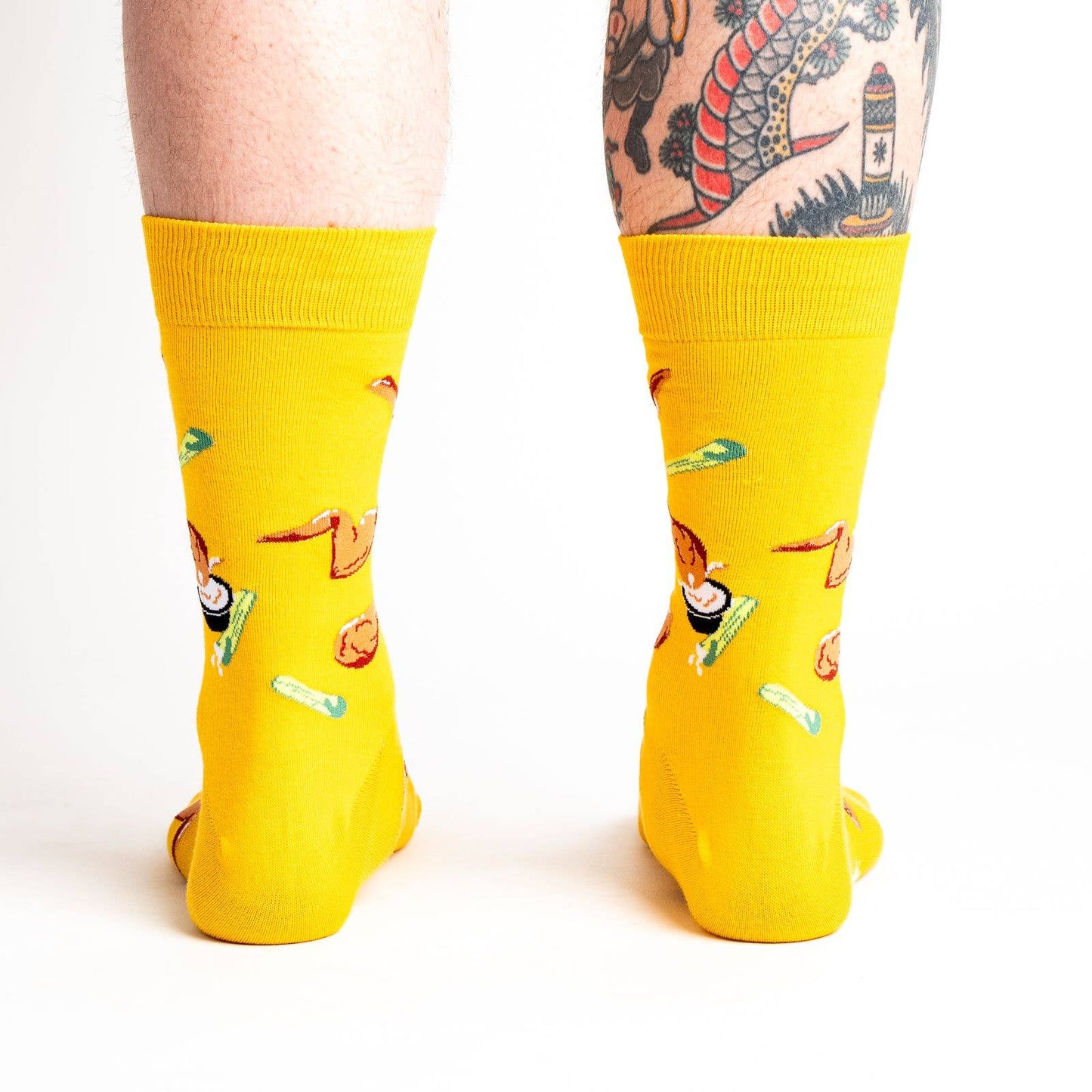 bright yellow socks with fried chicken wings, celery sticks and bleu cheese all over it