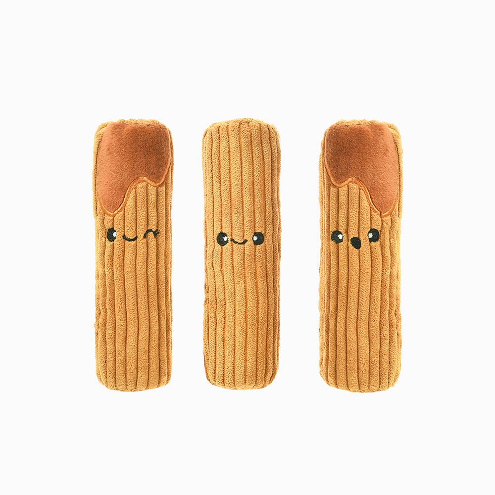 Three plush toys shaped like churros with smiling faces on a white background