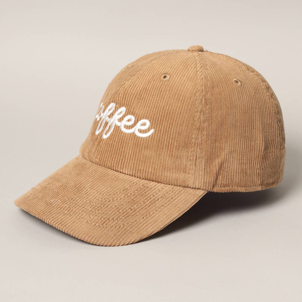 angled view of the tan/light brown corduroy baseball cap with white embroidered text on it that says "coffee"