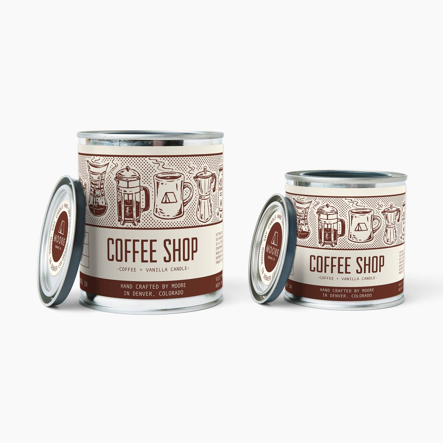 Two 'Coffee Shop' candles with decorative labels on a white background