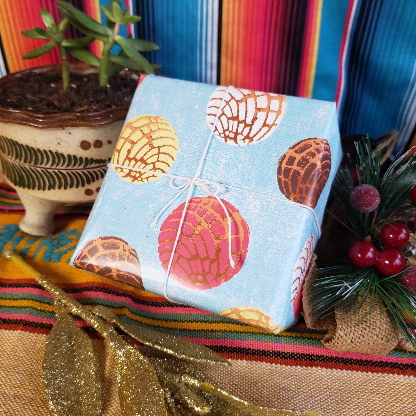 Gift displayed with holly and cactus.