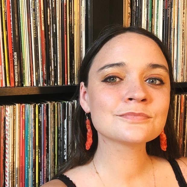 Hot cheeto earrings worn on woman