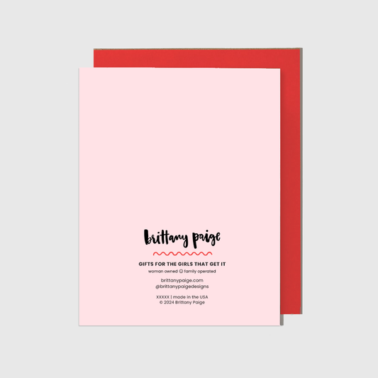 Pink card with red envelope on a light gray background