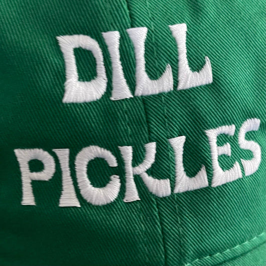 Close up of green baseball style hat with white stitching that reads "Dill Pickles"