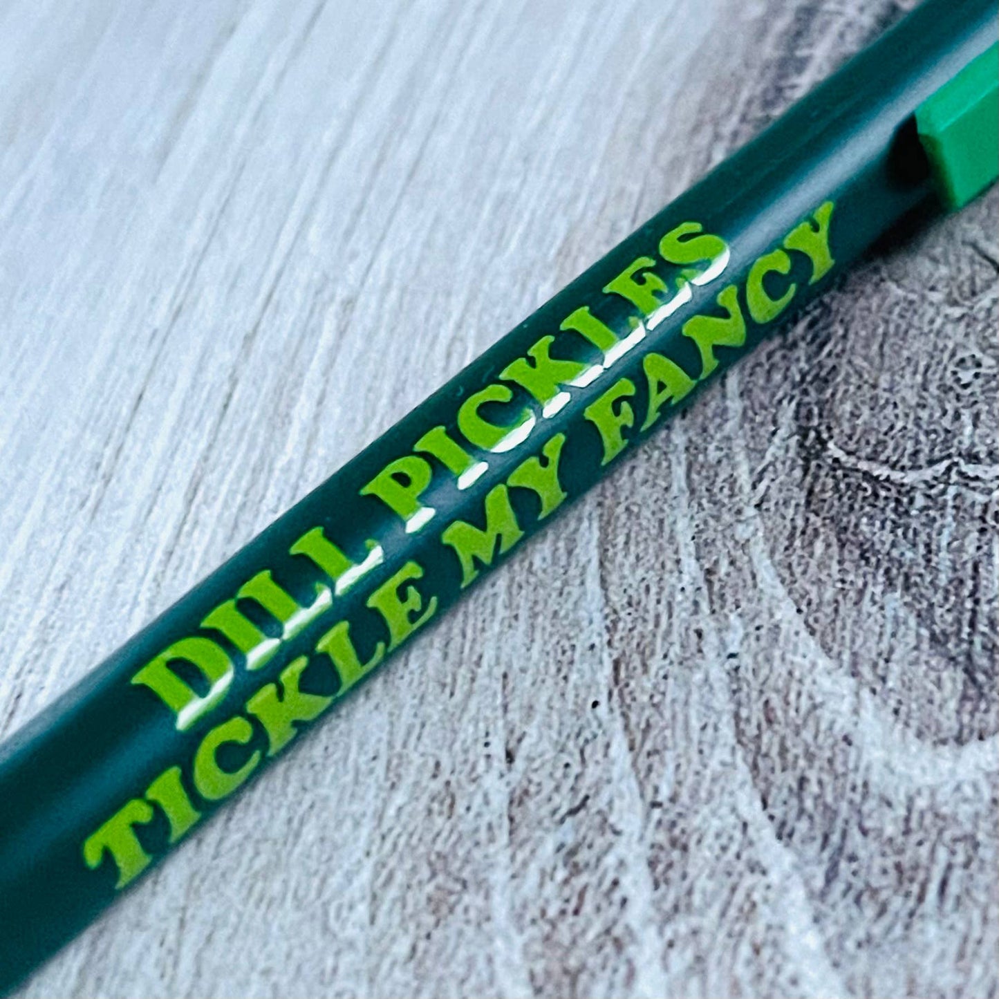 dark and light green pen with text on it that reads "Dill pickles tickle my fancy"