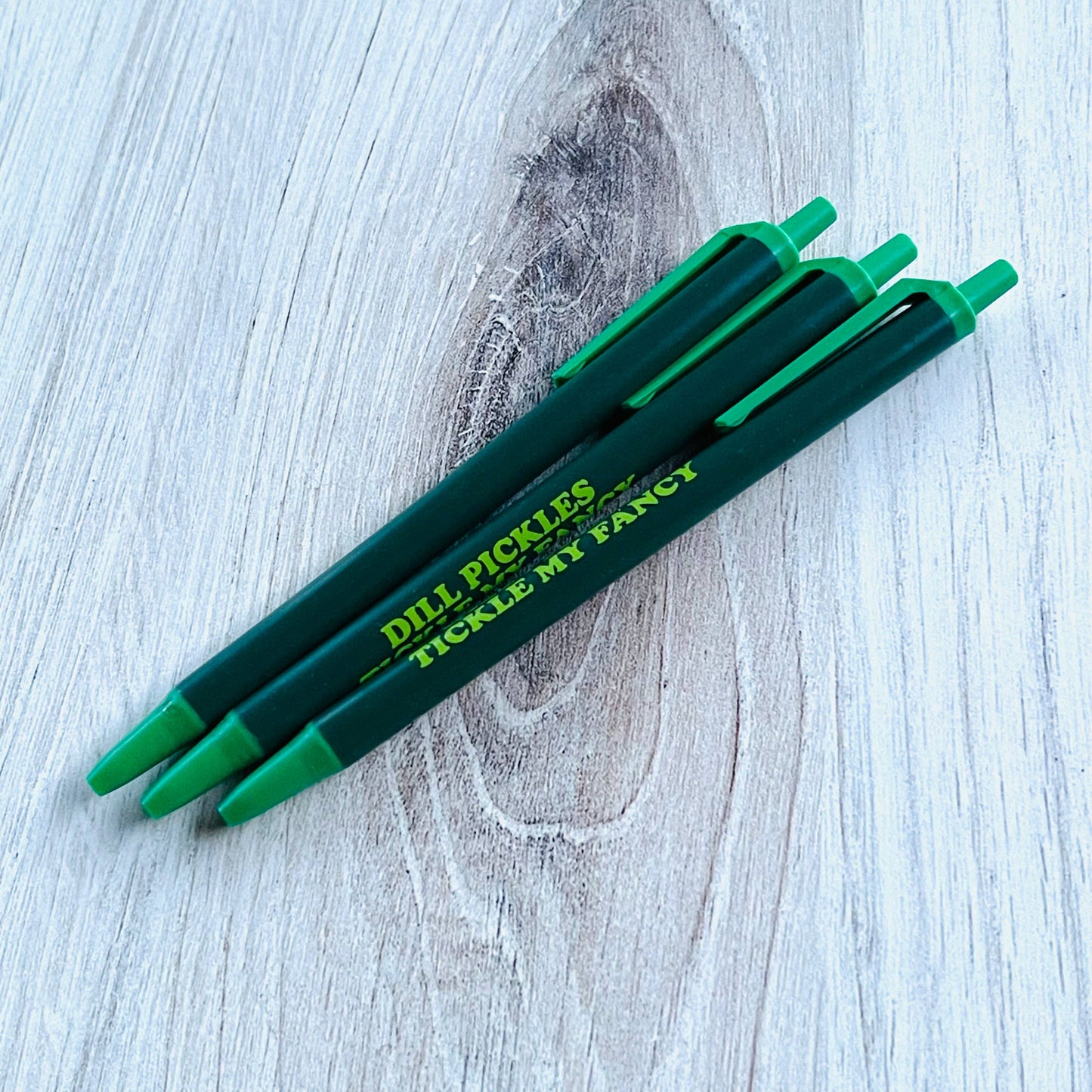 dark and light green pen with text on it that reads "Dill pickles tickle my fancy"