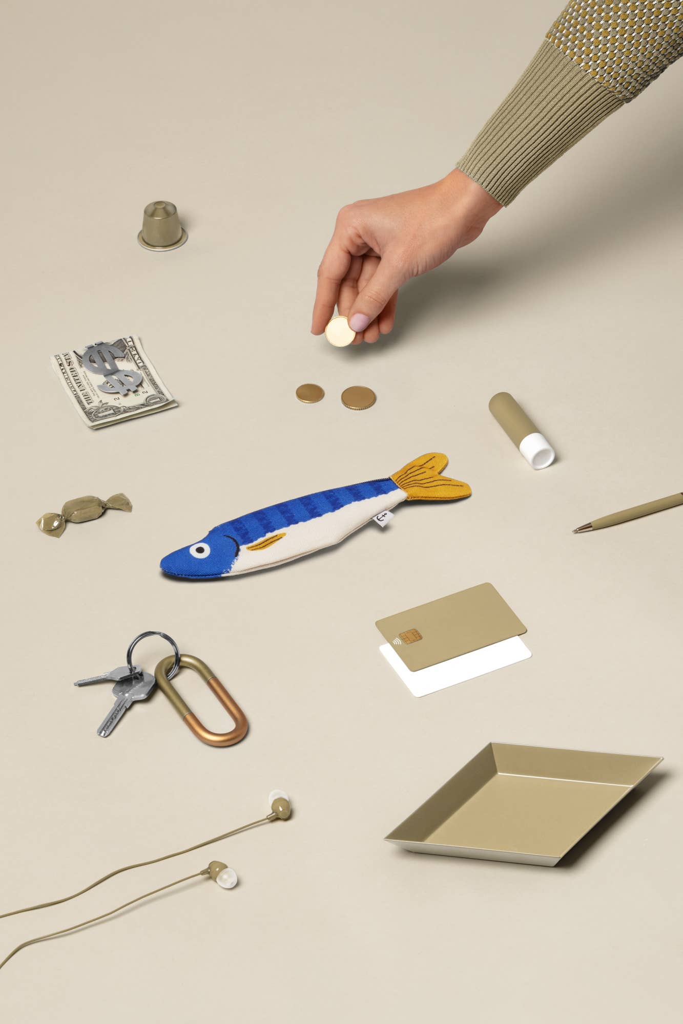 Flat lay of herring fish pouch with other various small items for scale