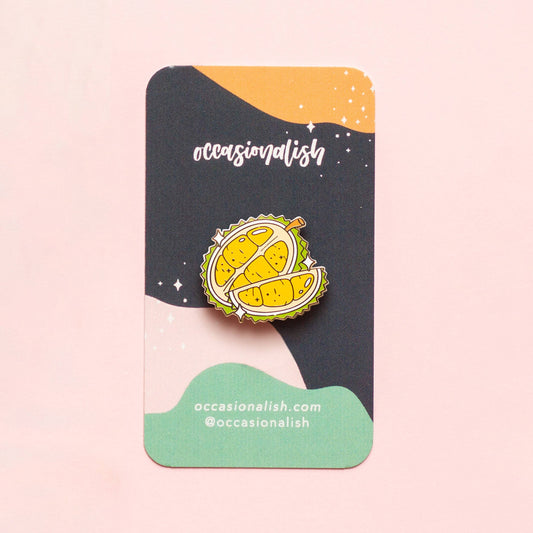 enamel pin of a durian fruit on card backing