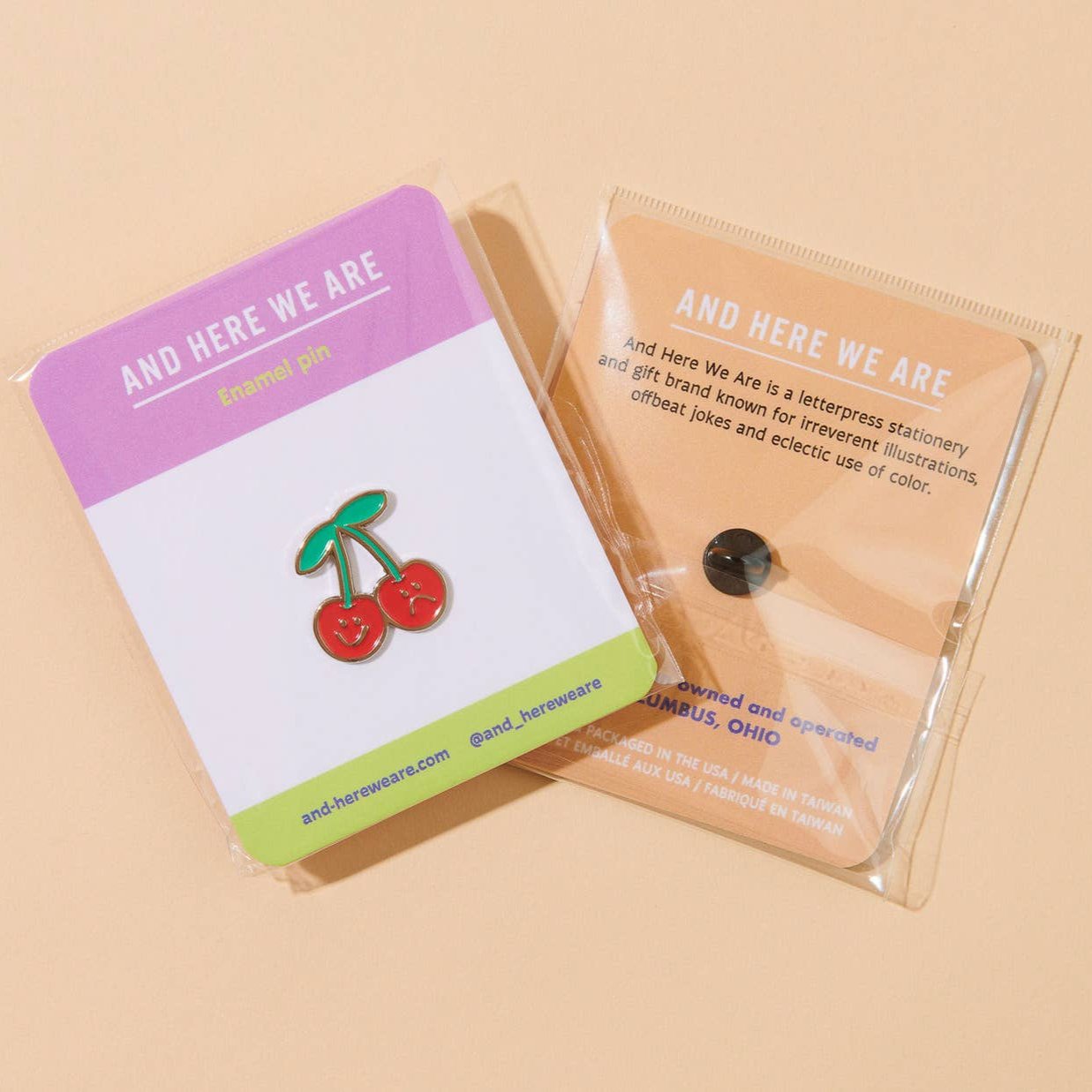 Duo of cherries one with a smiley face and the other with a sad face -- in packaging