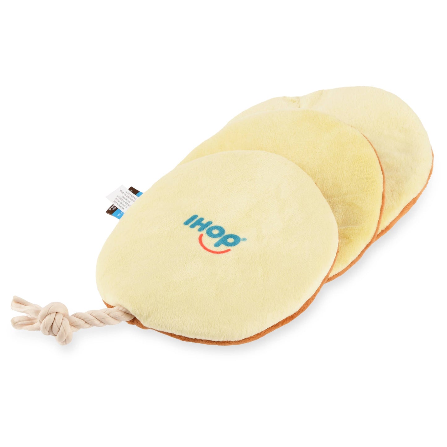Underside of pancake dog toy with a rope and 'ihop' branding on a white background