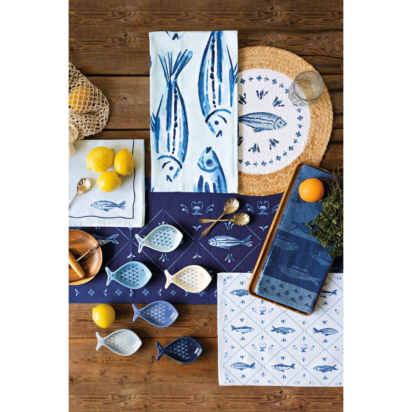 Collection of decorative items with fish patterns on a wooden surface