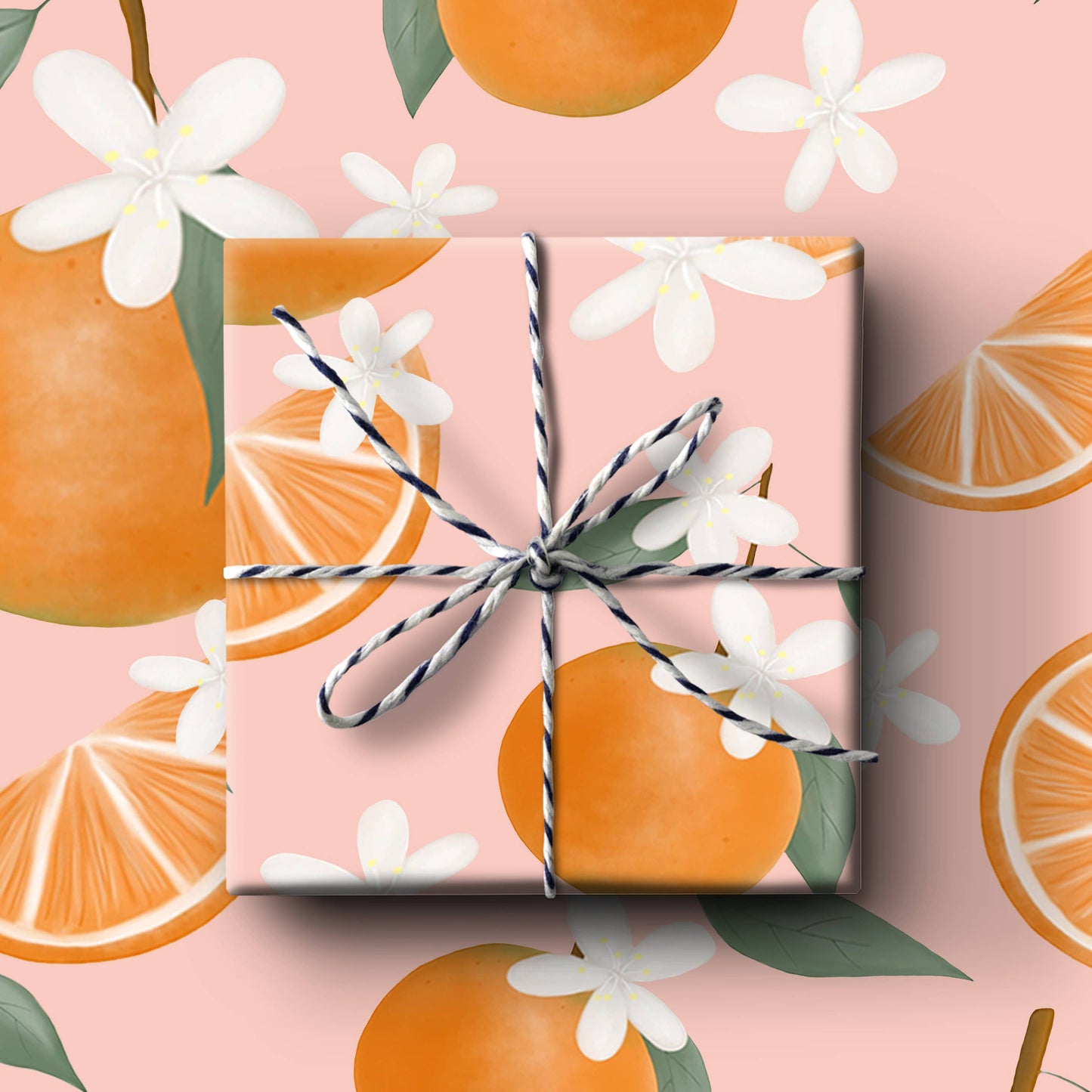 Gift box with decorative string on a pink background with orange and floral illustrations
