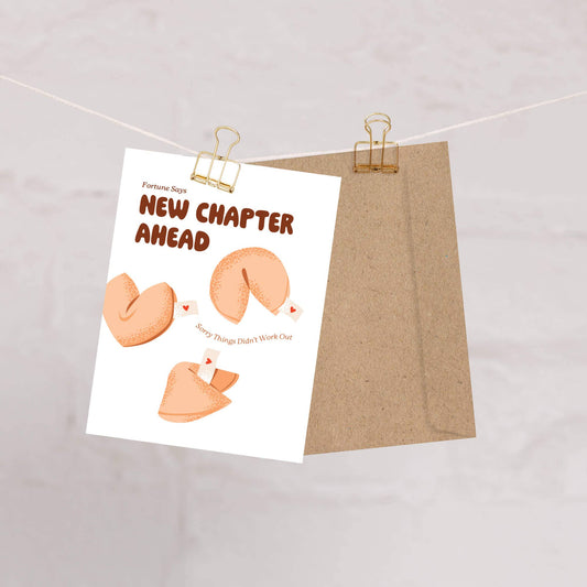 Greeting card with fortune cookies and text 'Fortune Says New Chapter Ahead, Sorry Things Didn't Work Out' on a white background.