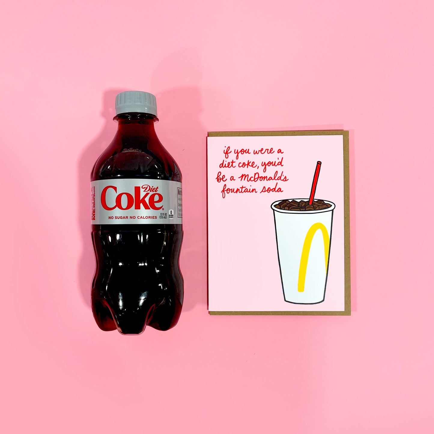 an actual diet coke laid next to the fountain soda/diet coke card