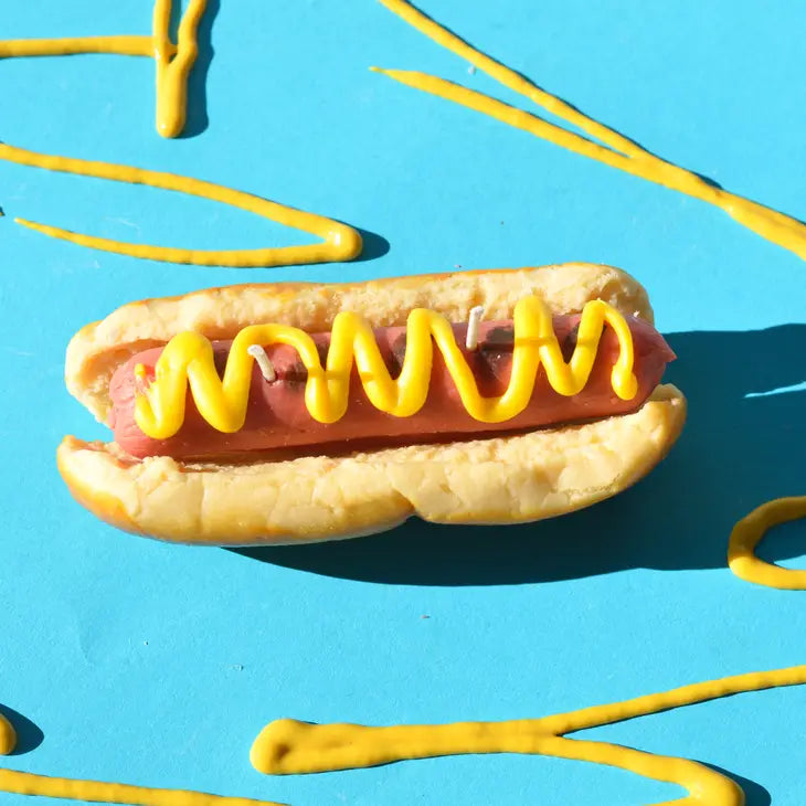 Hot dog candle with mustard from above