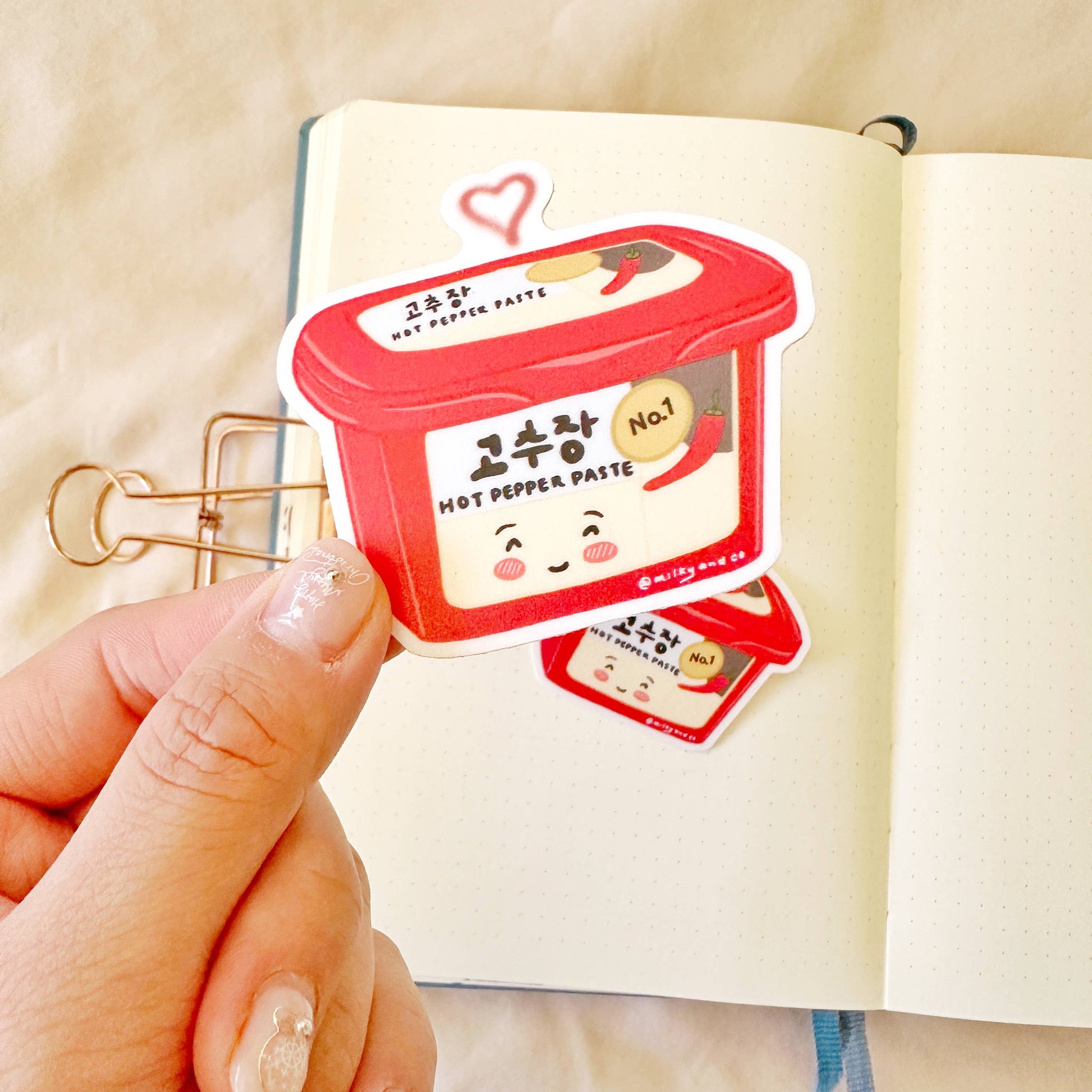 Sticker of a tub of gochujang (Korean spicy pepper paste)