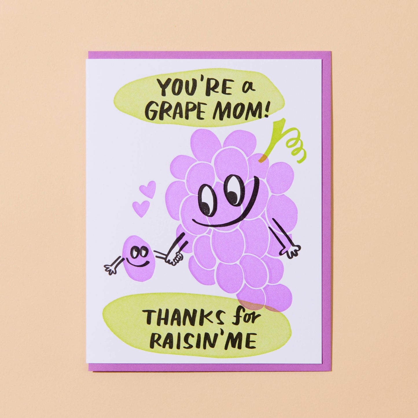 card with an illustrated grape bunch holding an illustrated, single raisin's hand. Text reads "You're a grape mom! Thanks for raisin' me"