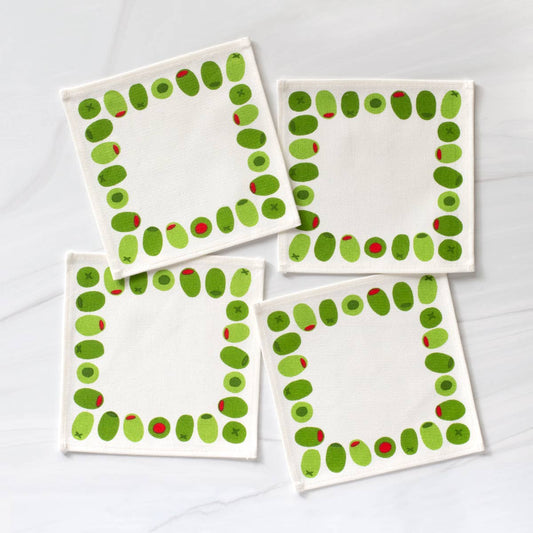 Four square cloth cocktail napkins with green stuffed olive design on a white background