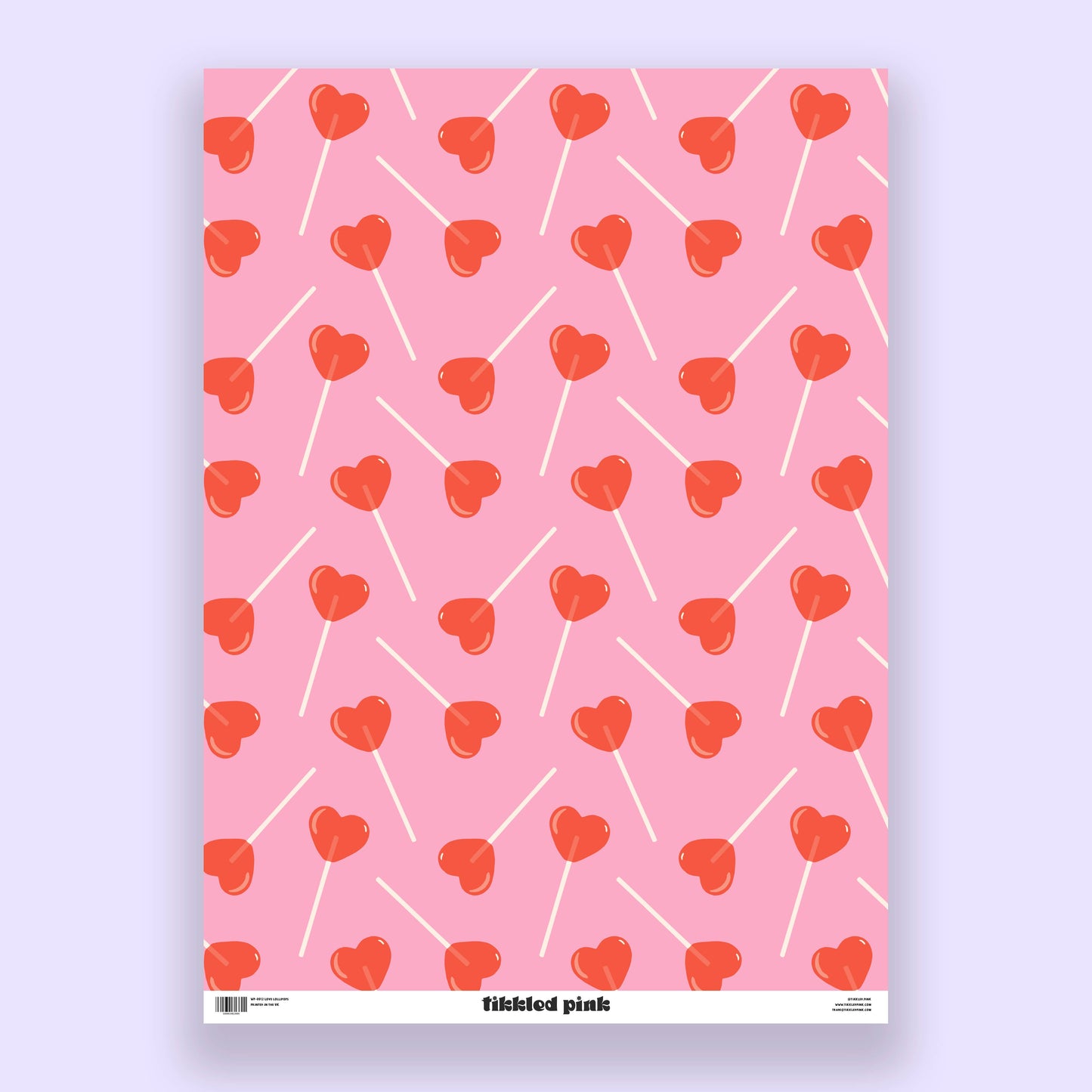 sheet of pink gift wrap with red, heart-shaped lollipops all over