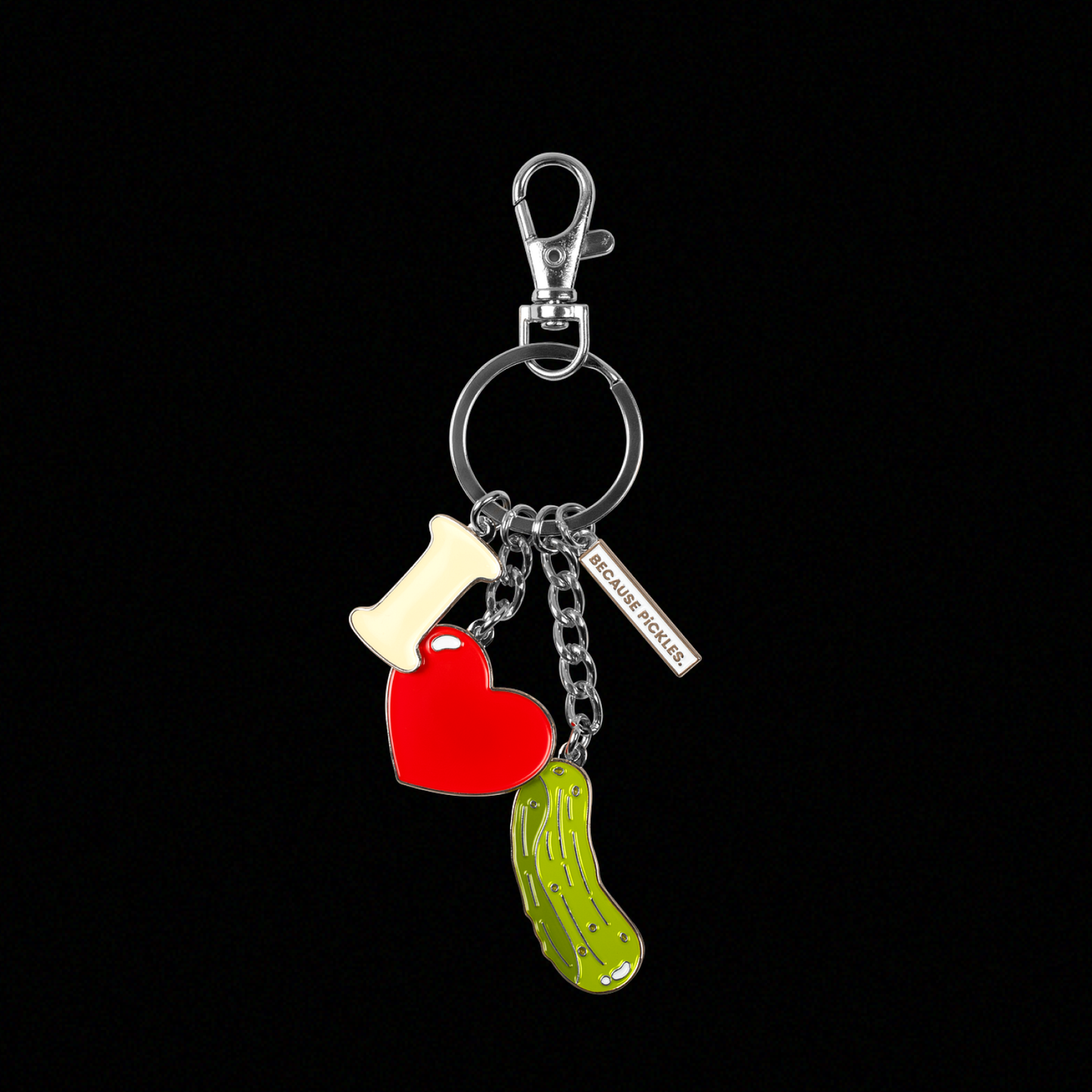 Keychain with heart, letter "i" and pickle charms on a black background