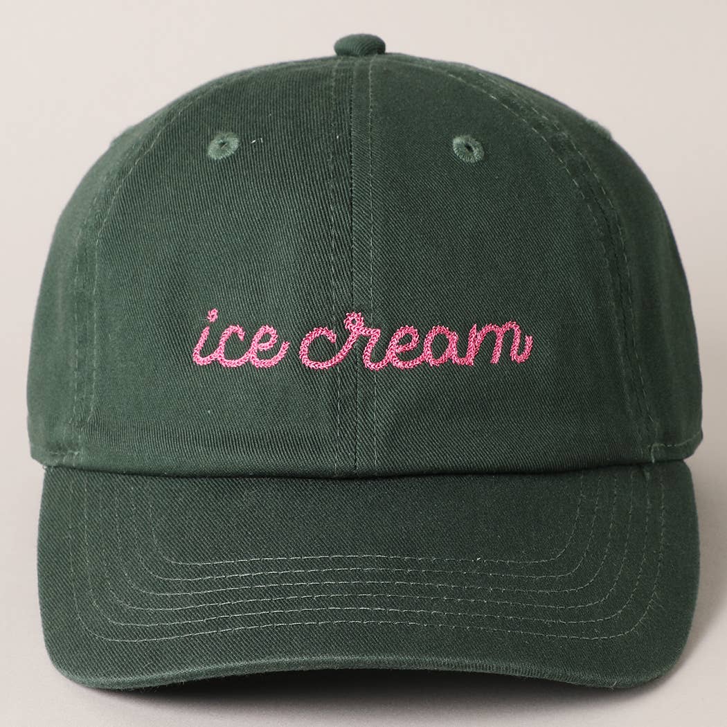Green cap with 'ice cream' embroidered in pink on a beige background