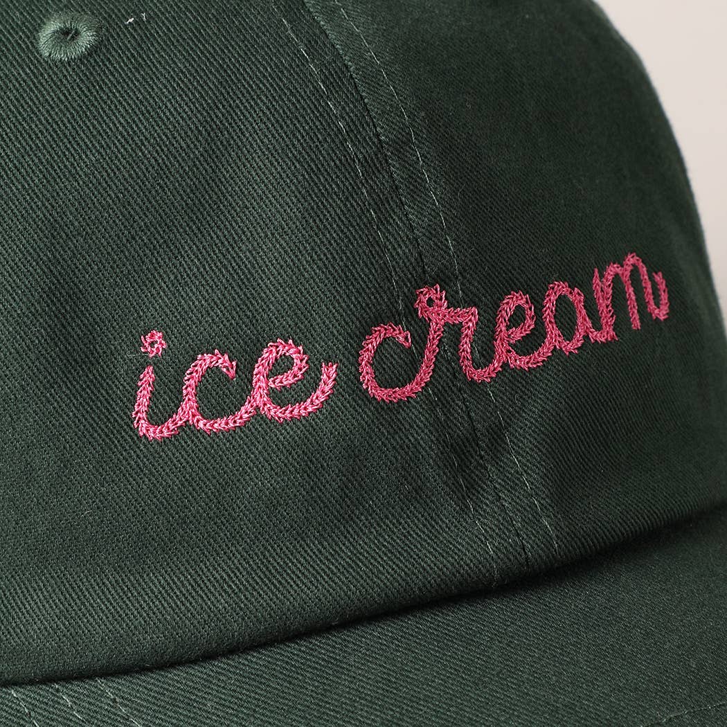 close up details of embroidery on black ice cream hat