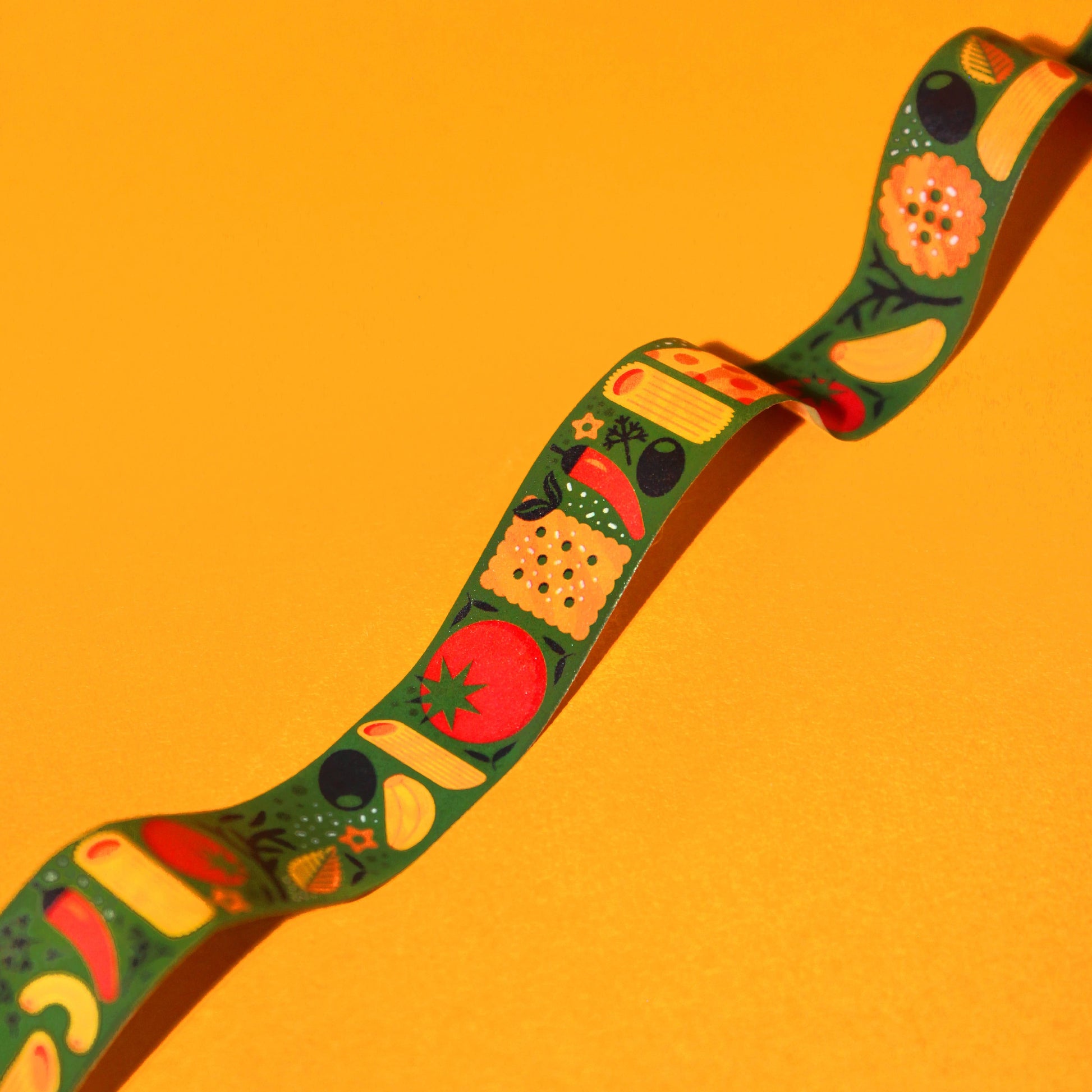 Dark green washi tape, featuring various kinds of italian cuisine including olives, garlic, pasta, tomatoes, peppers, crackers, herbs and cheese