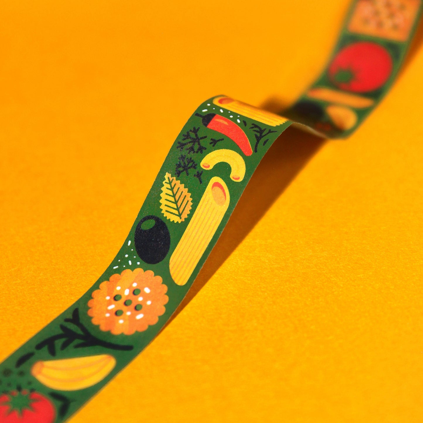 Dark green washi tape, featuring various kinds of italian cuisine including olives, garlic, pasta, tomatoes, peppers, crackers, herbs and cheese