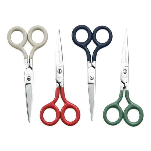 Photo of four stainless steel scissors on white background.