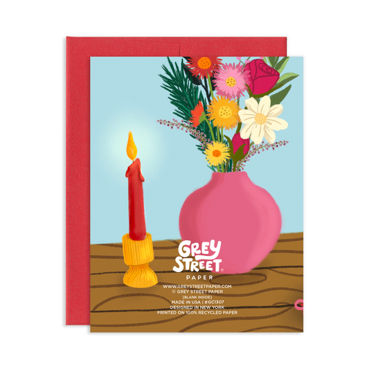 Greeting card with a pink vase of flowers and a lit candle, featuring 'Grey Street Paper' branding.