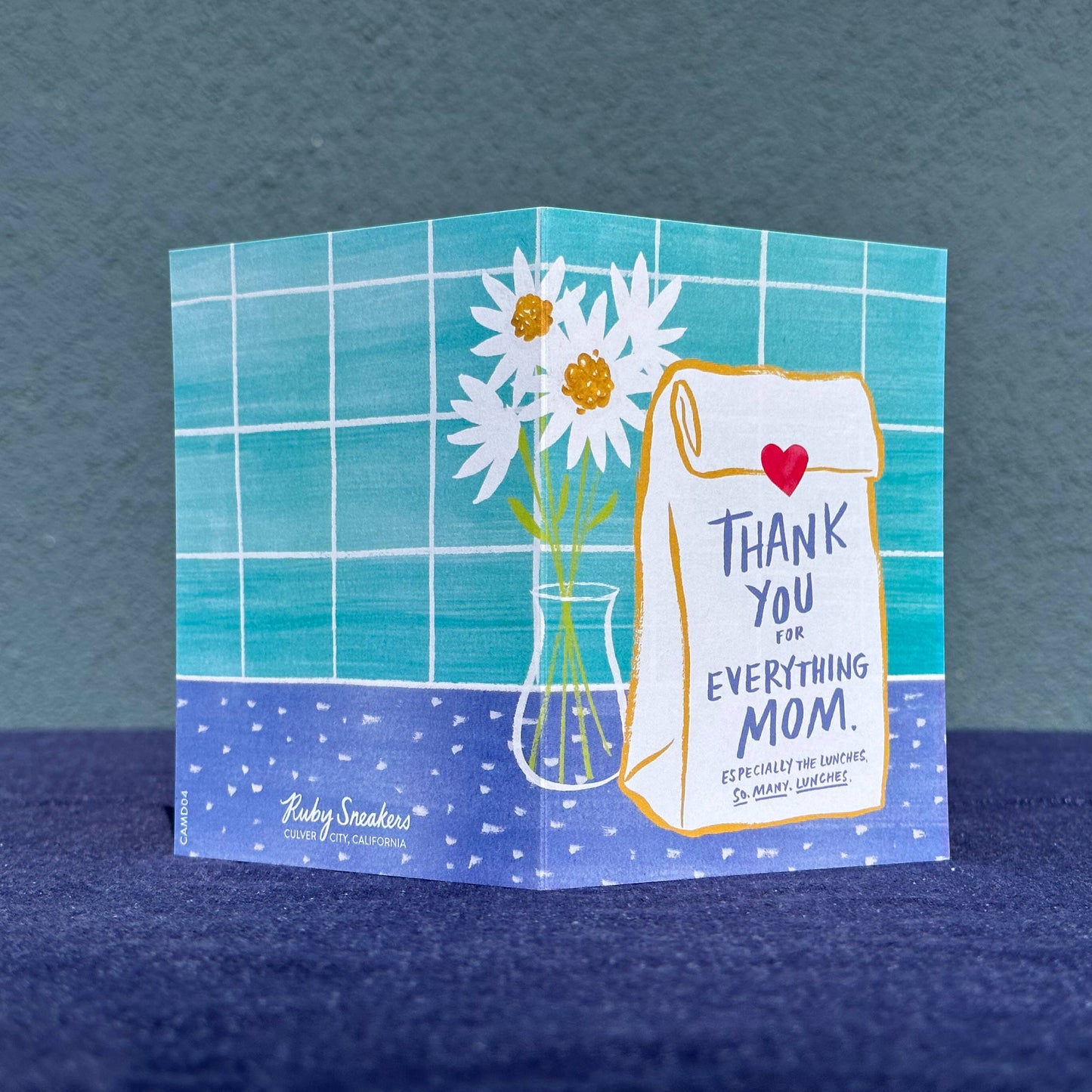 Greeting card with flowers and text on a blue background