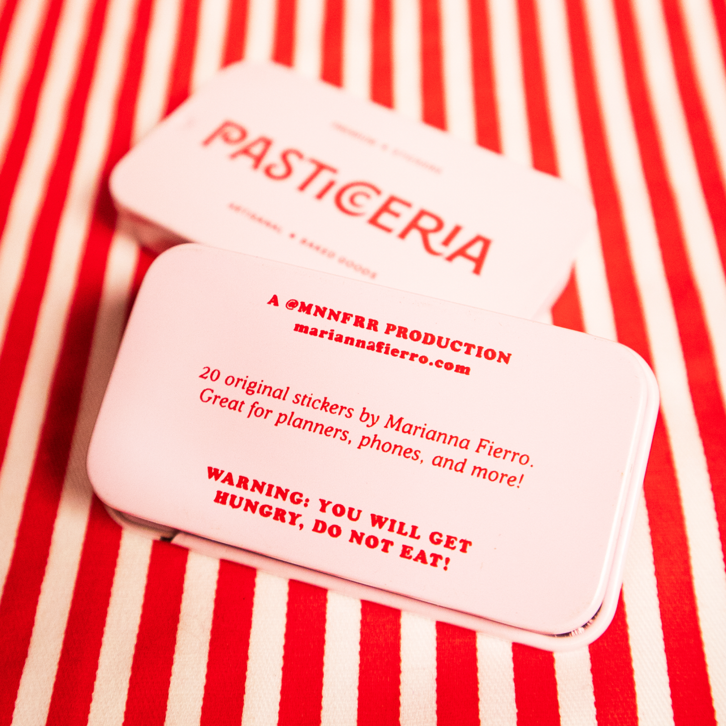 front and back of the tin sticker box. Back text includes artist's website, along with "20 original stickers by Marianna Fierro. Great for planners, phones and more! WARNING: YOU WILL GET HUNGRY, DO NOT EAT!"