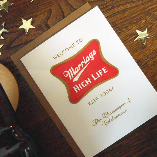 Card with 'Marriage High Life' design on a wooden surface
