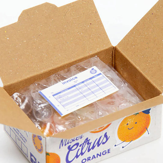 Open box of 'Navel Citrus Orange' with a visible invoice sticker inside