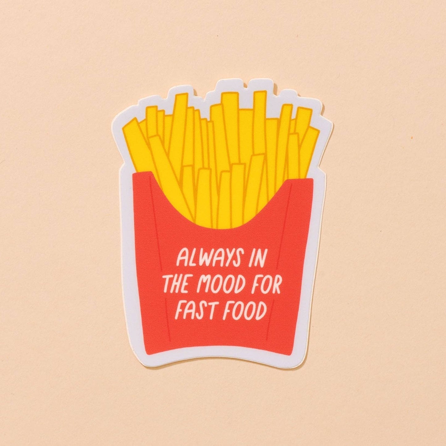 design of sticker is french fries in classic red container. Text on container reads "always in the mood for fast food"