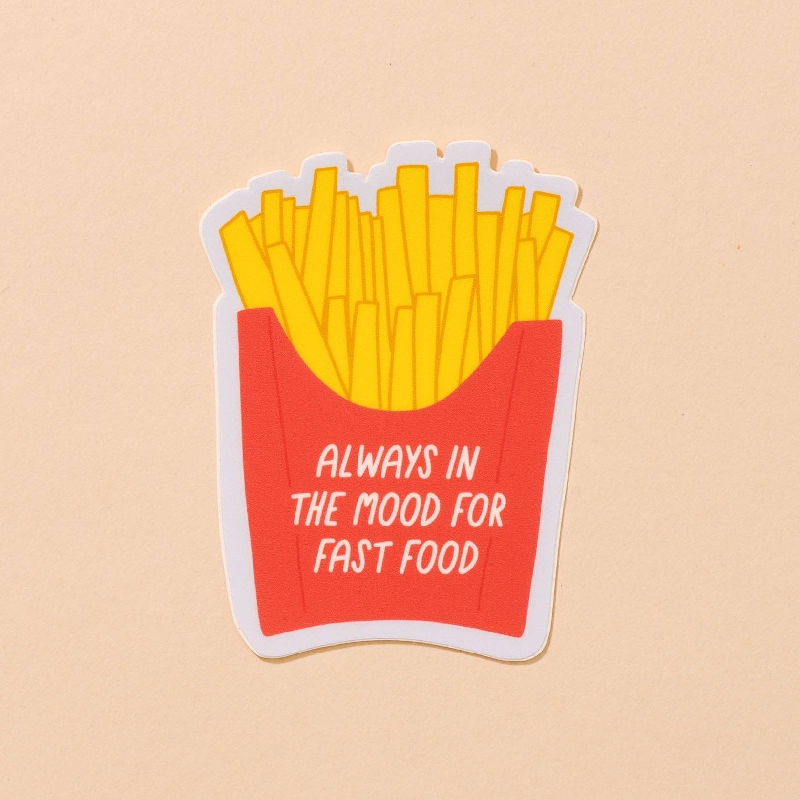 design of sticker is french fries in classic red container. Text on container reads "always in the mood for fast food"