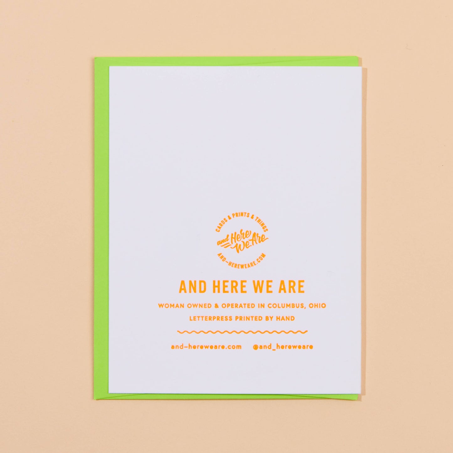 White card with yellow text and green border on a beige background