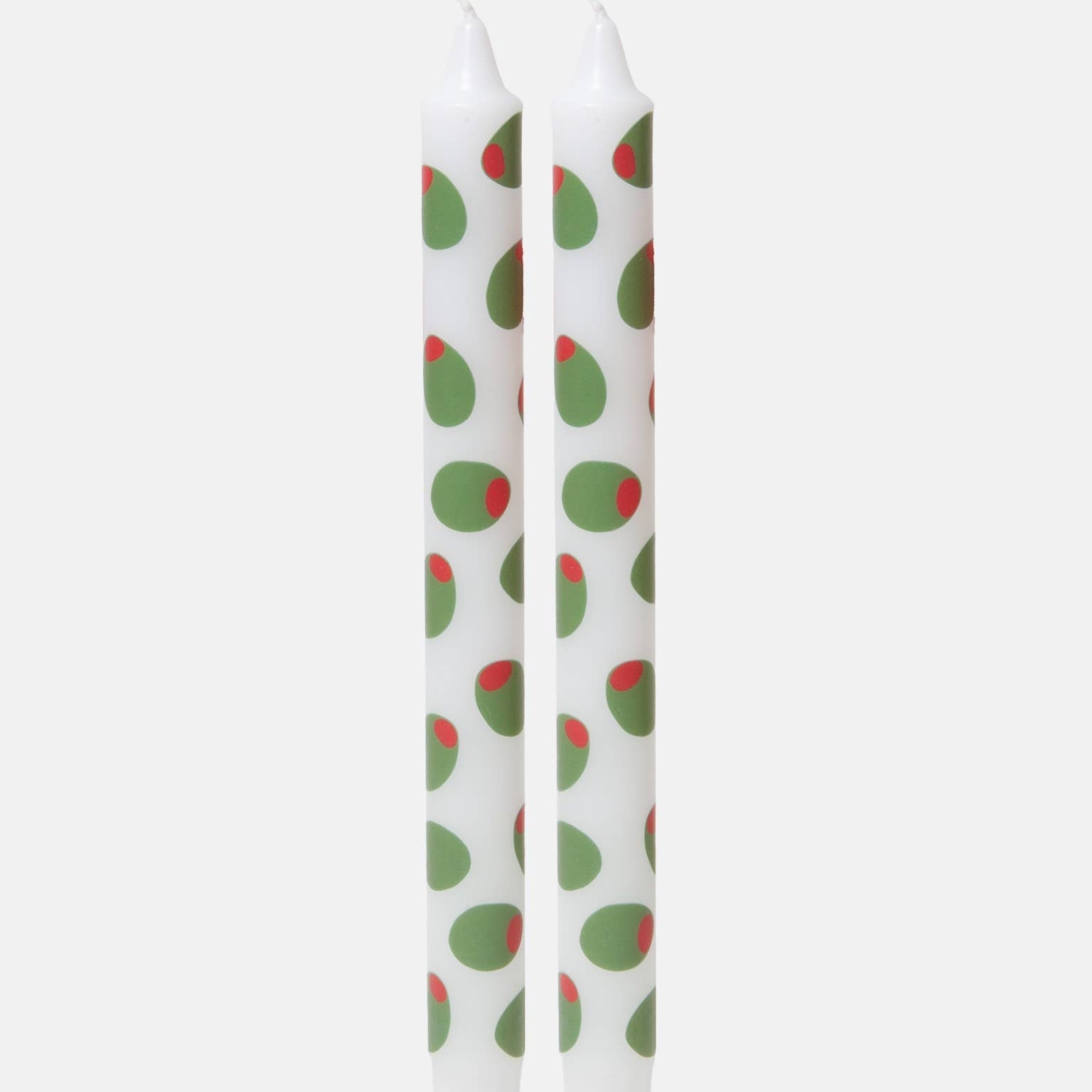 Two white candles with stuffed green olive design pattern on a white background