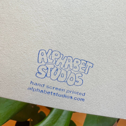 back of the card with the name of the studio on it