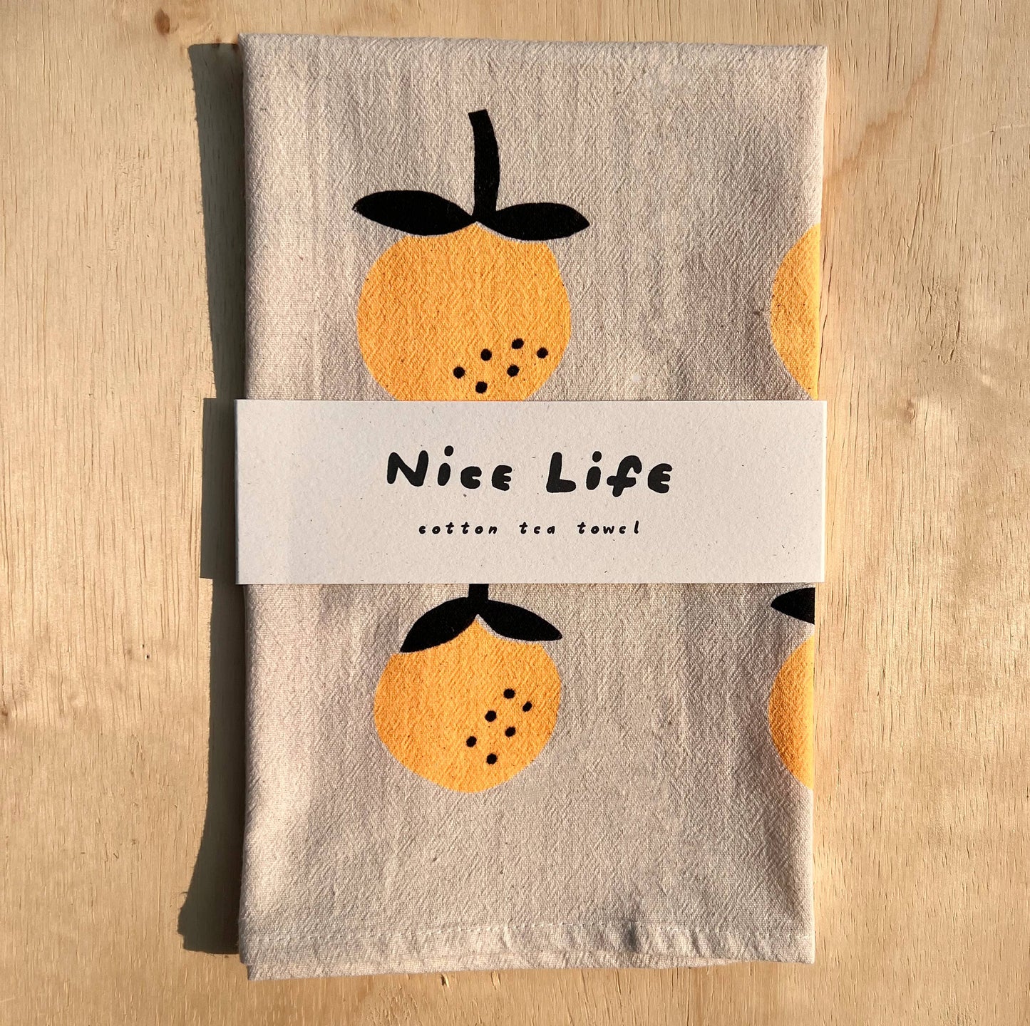 Linen tea towel with oranges screen printed on it